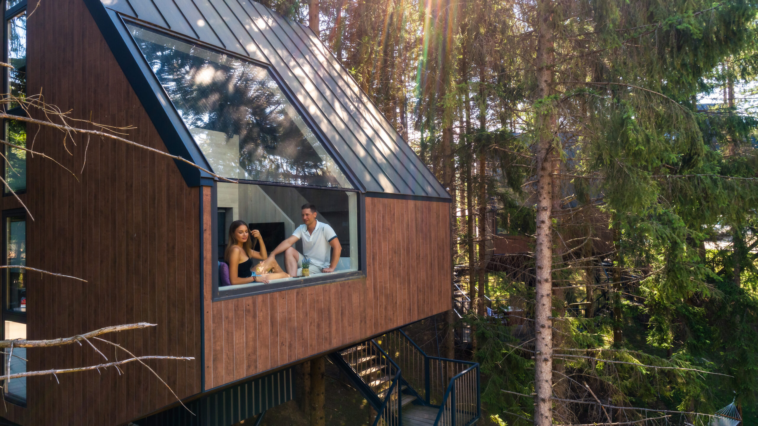 A treehouse at Plitvice Holiday Resort with a couple relaxing