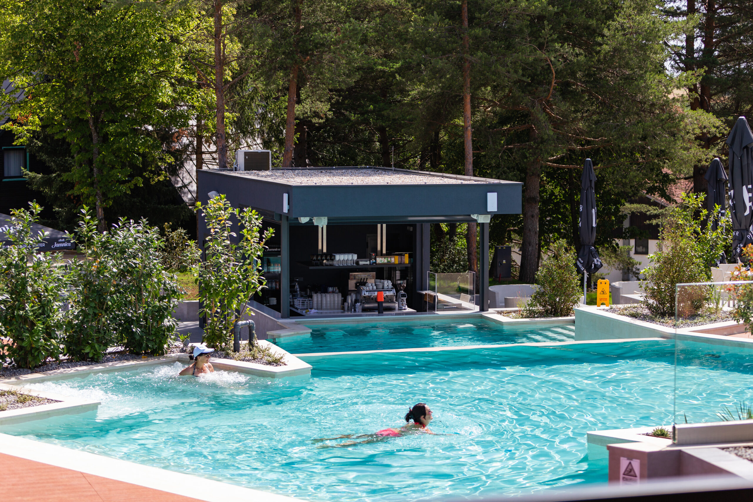 A pool and a poolside bar at Plitvice Holiday Resort